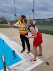 CAO & Staff standing over outdoor pool